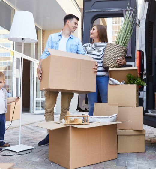 Family carrying boxes and household items into a moving van during a Perth to Karratha relocation